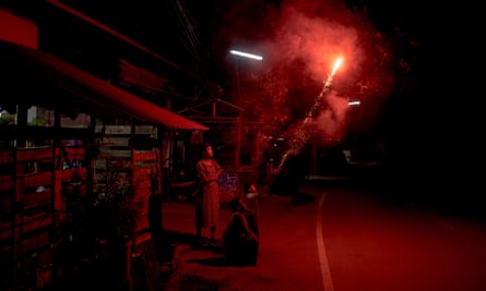 Burmese migrant families let off fireworks outside their home as they celebrate Tazaungdaing festival in Mae Sot last month.
