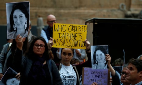 People attend a vigil and demonstration in Valletta, Malta, to mark seventh months since the murder of the anti-corruption journalist Daphne Caruana Galizia.