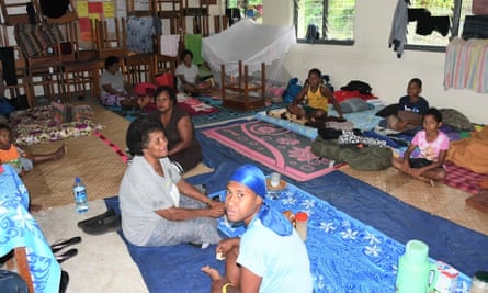 People take shelter inside an evacuation center in Suva, Fiji, ahead of Cyclone Yasa.