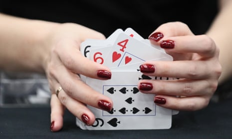 A croupier shuffles cards for a game of poker.