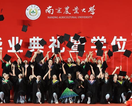 Graduates toss their caps in the air at a graduation ceremony at Nanjing Agricultural University