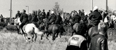 Mounted police charge through the picket lines.