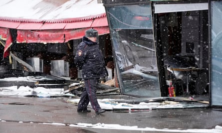 A police officer walks by the site of the explosion in St Petersburg