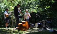 A band gather to practise in a sunny garden.