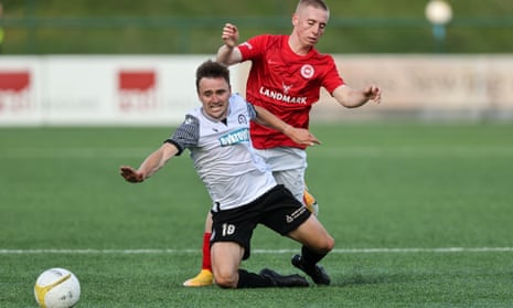Paul Rutherford of Bala Town and Conor McKendry of Larne FC (right) tussle, with Larne winning 2-0 over two legs.