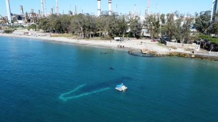 An outlined wreck is seen from above a few metres offshore in the Bay of Algeciras