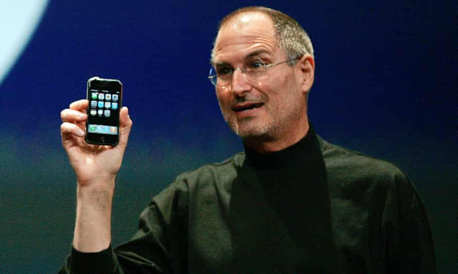Apple Chief Executive Officer Steve Jobs holds the new iPhone in San Francisco.