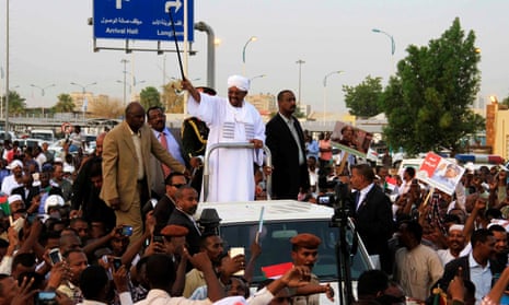 Omar al-Bashir greets cheering supporters at Khartoum airport