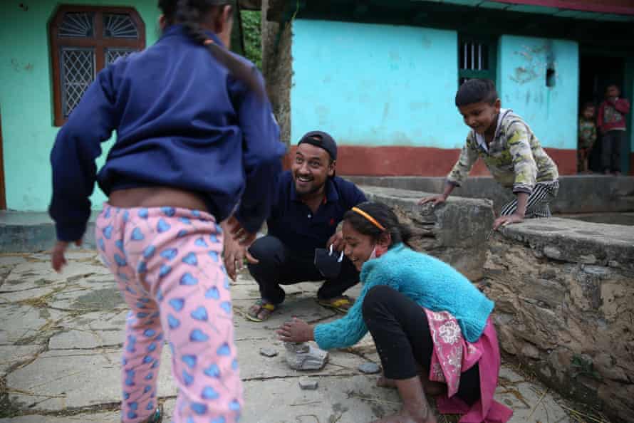 Prem Singh, a local activist, plays with children in Durmi village, near Pagna.