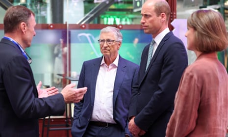 Bill Gates and Prince William listen to a delegate at a conference venue