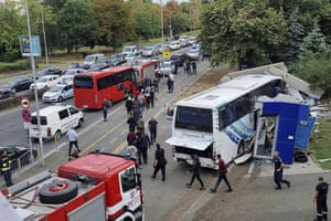 Burgas, Bulgaria. Police escort migrants on to a bus at the scene of an incident in the Black Sea city of Burgas