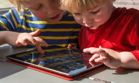 Two children playing on an iPad