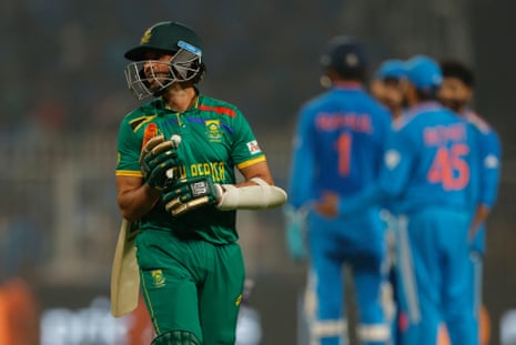 South Africa's Keshav Maharaj walks after losing his wicket, bowled out by India's Ravindra Jadeja.