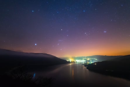 Eifel national park at night, with lights in the distance between two bits of land sloping into the water