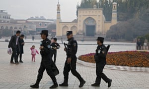 Uighur security personnel patrol near the Id Kah Mosque in Kashgar in western China’s Xinjiang region. China has threatened to retaliate against the US’s new Uighur human rights law.