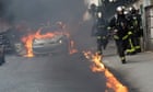 Police car set on fire as officers and protesters clash in Paris