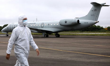 A health worker walks near a Brazilian air force airplane in Manaus before it takes off with Covid-19 patients to Piaui state on Friday.