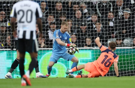 Newcastle keeperAaron Ramsdale (centre) makes a save in front of Fermin Lopez of Barcelona.