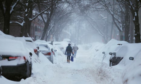 Pedestrians make their way along a snowy street in Cambridge, Massachusetts. The Weather Channel app is marketed as ‘the world’s most downloaded weather app’.