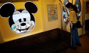A staff member disinfects a Disney Resort line train during the reopening of Tokyo Disneylandon 1 July 2020.