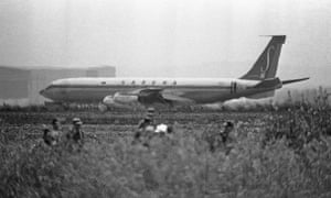Israeli troops patrol around the plane.
