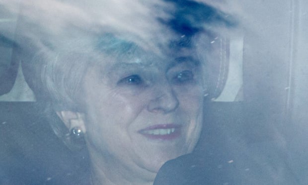 Theresa May smiles as she leaves parliament on Thursday.