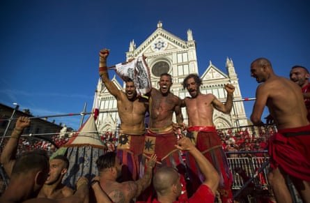 The red team of Santa Maria Novella celebrate after winning their semi-final at Piazza Santa Croce.