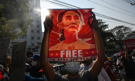 A demonstrator holds a poster of ousted leader Aung San Suu Kyi at a coup protest last year in Yangon