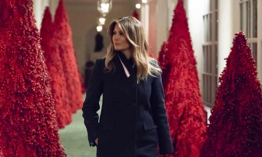 Melania Trump reviews a display of blood red topiary trees in 2018.