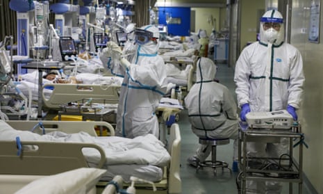 Medical workers treating patients in the isolated intensive care unit at a hospital in Wuhan, Hubei province. 