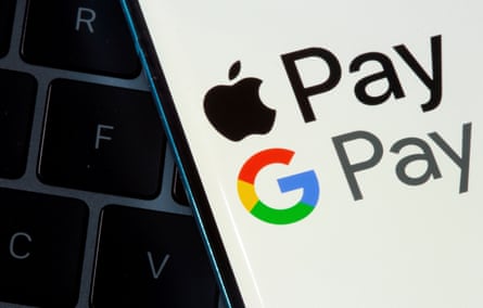 A smartphone with Apple Pay and Google Pay logos is placed on a laptop