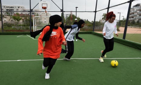 Teens training on a public football pitch just outside Paris.
