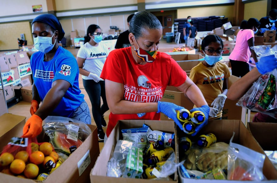 Volunteers prepare boxes of food from the Second Harvest Food Bank of Central Florida for distribution in July 2020.