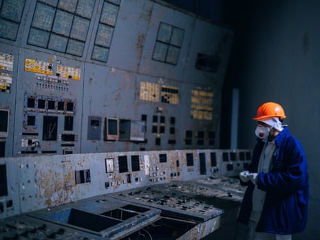 a person in a hard hat inside the control room of reactor No 4 where the disaster happened in 1986.