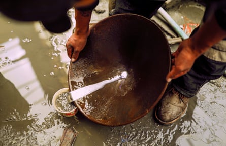 Man swills liquid around bowl.