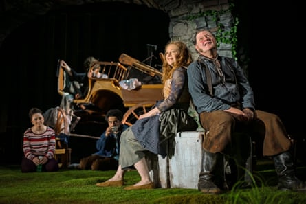 In Refuge, actors Hannah von Peinen and Holger Kraft sit on a crate near a wooden cart on stage