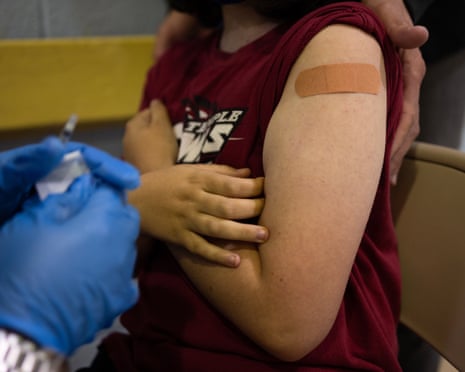 a child's arm with a band-aid on it after getting a vaccine