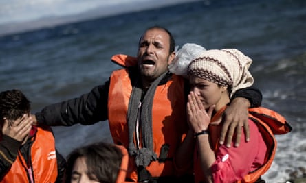A refugee family weeps after arriving on Lesbos