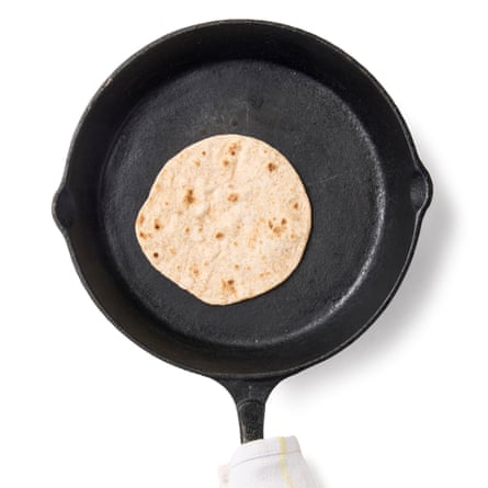 Lay one bread in the hot pan, leave to cook until small bubbles appear on the surface, then use tongs or a spatula to flip it over. Cook for another 40-60 seconds, pressing down lightly with a spatula as it puffs up, until speckled brown on the underside