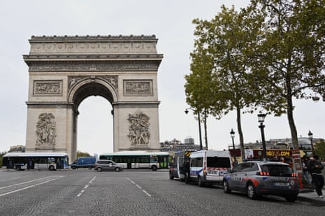 Police vans parked in front of the Arc de Triomphe