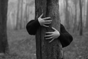 A child hugs a tree