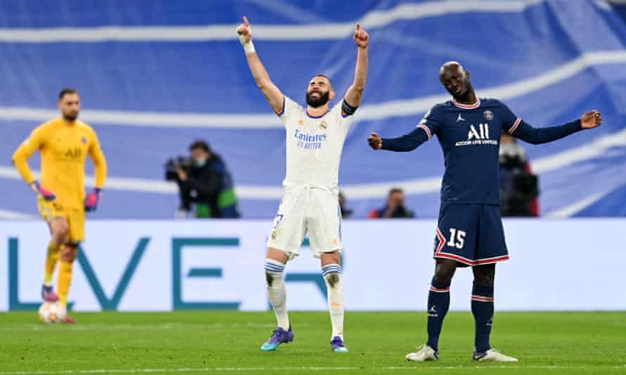 Karim Benzema of Real Madrid (centre) celebrates after scoring their team’s second goal as Danilo Pereira of Paris Saint-Germain (right) looks dejected.