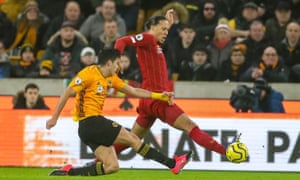 Liverpool’s Virgil Van Dijk blocks a shot by Raul Jimenez.