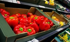 Fresh red peppers and other produce in a  supermarket