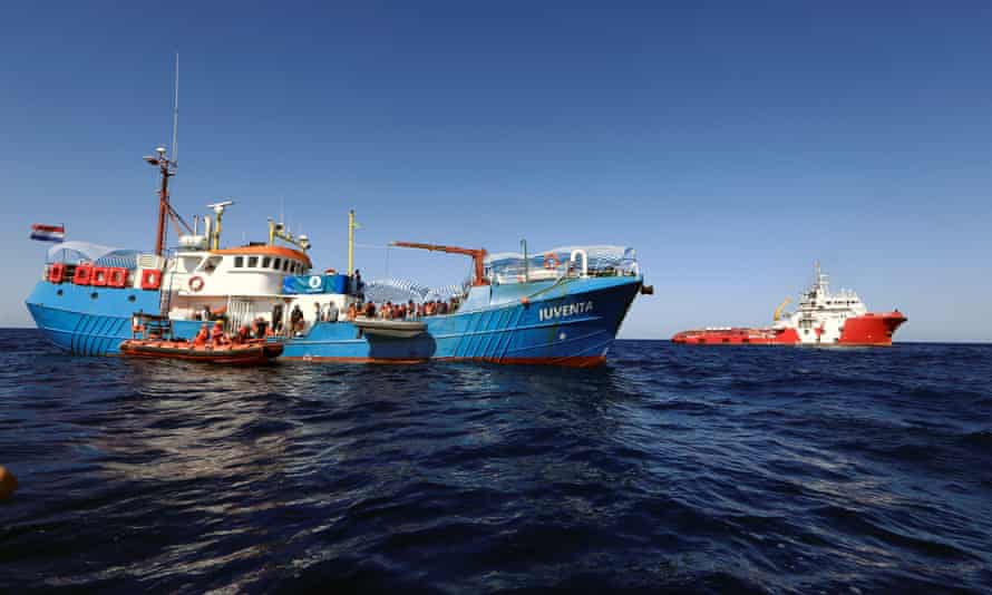 Rescuers from Save the Children transfer migrants from the Iuventa to their own ship during an operation off the Libyan coast in September 2016