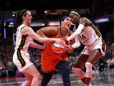 Indiana Fever’s Caitlin Clark (left) and Temi Fagbenle combine to thwart an attack by Brionna Jones of the Connecticut Sun.