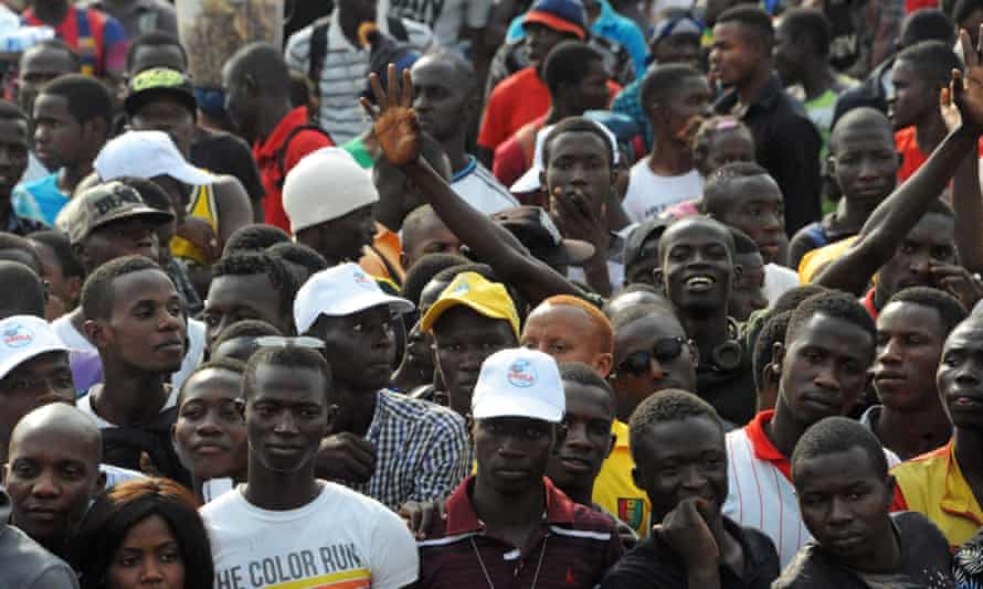 Crowds cheer during the “Bye bye, Au revoir Ebola” (Bye bye, Goodbye Ebola) concert in December, celebrating the end of the disease in Guinea