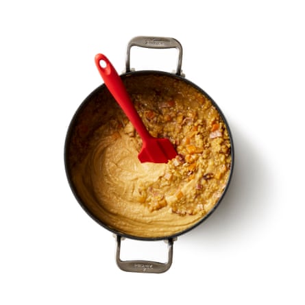 Bring to a simmer, then turn down the heat, partially cover the pan and leave to cook for about 45 minutes, until the vegetables are soft and the lentils have mostly broken down. Scoop out about a third of the soup, whizz it to a puree, then stir it back into the pot.