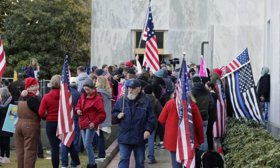 Pro-Trump and anti-mask demonstrators hold a rally outside the Oregon state capitol as legislators meet for an emergency session in Salem, Oregon, on 21 December 2020.