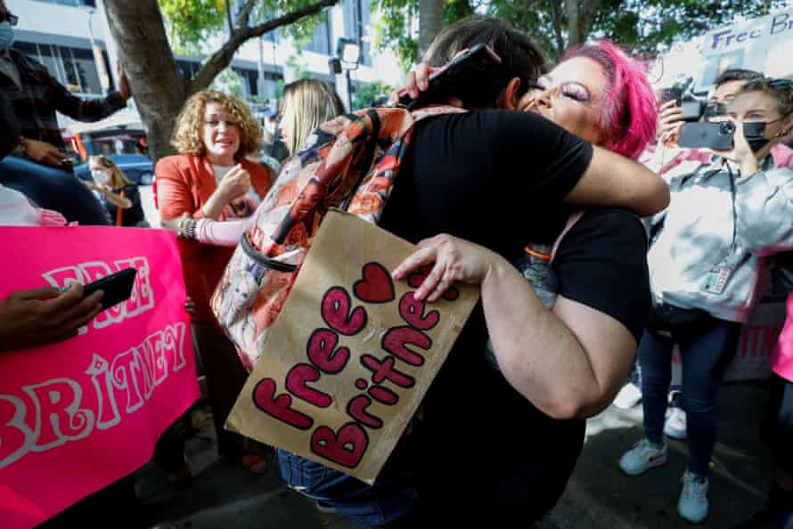Supporters of pop star Britney Spears hug after they hear the results of Wednesday’s hearing.